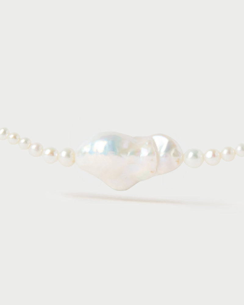 Modern pearl beaded necklace accented with a large irregular freshwater cultured pearl