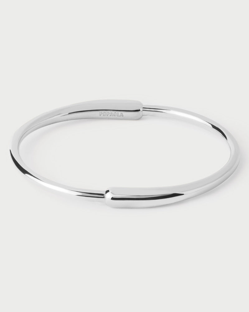 Modern silver tone bangle with asymmetric design and two elonganted drop-shaped motifs