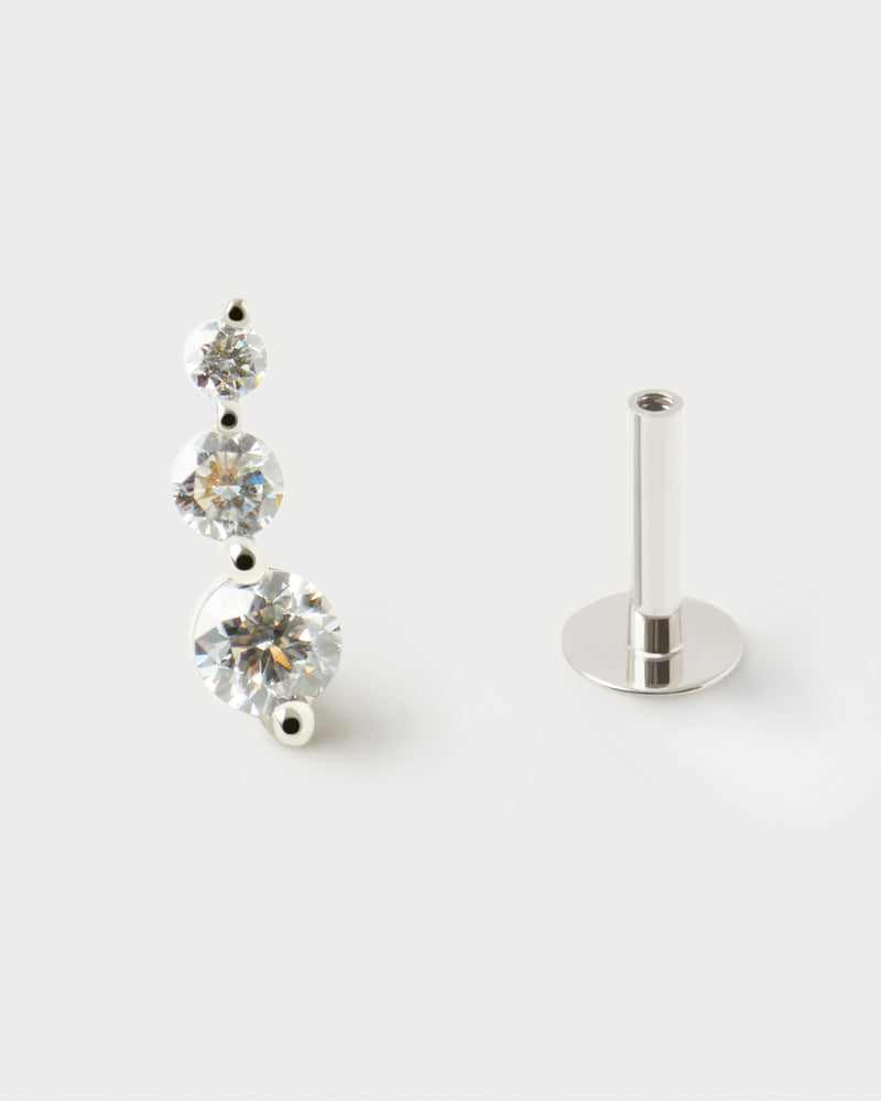 White gold ear piercing with three multiple-size lab-grown diamonds