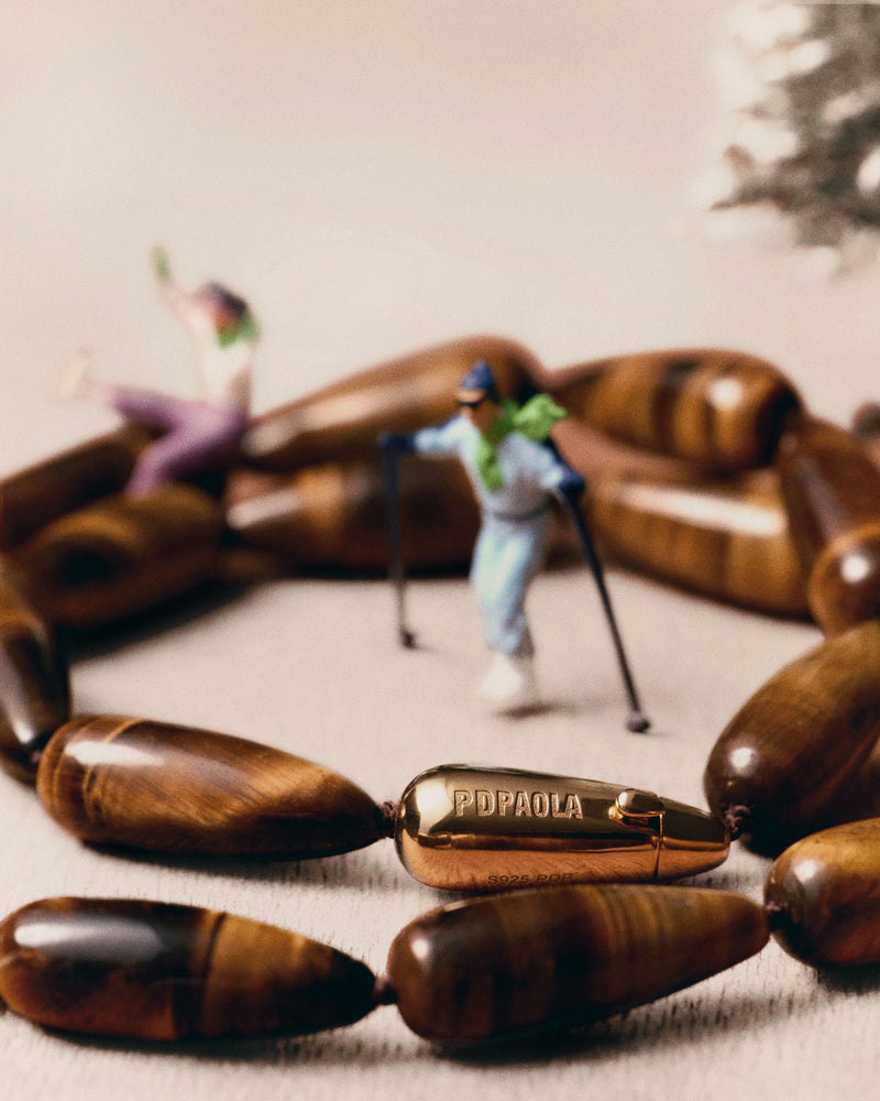 Modern choker featuring brown gemstone beads and signature drop closure