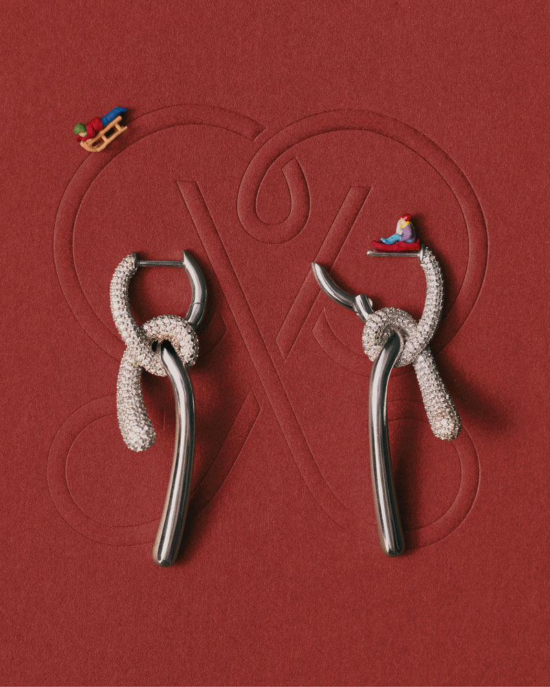 Elegant silver asymmetric hoop earrings with contrasting pavé zirconia knotted pendants