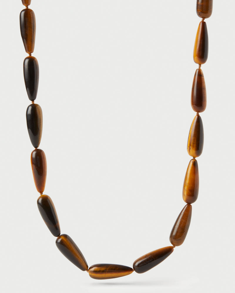 Modern choker featuring brown gemstone beads and signature drop closure