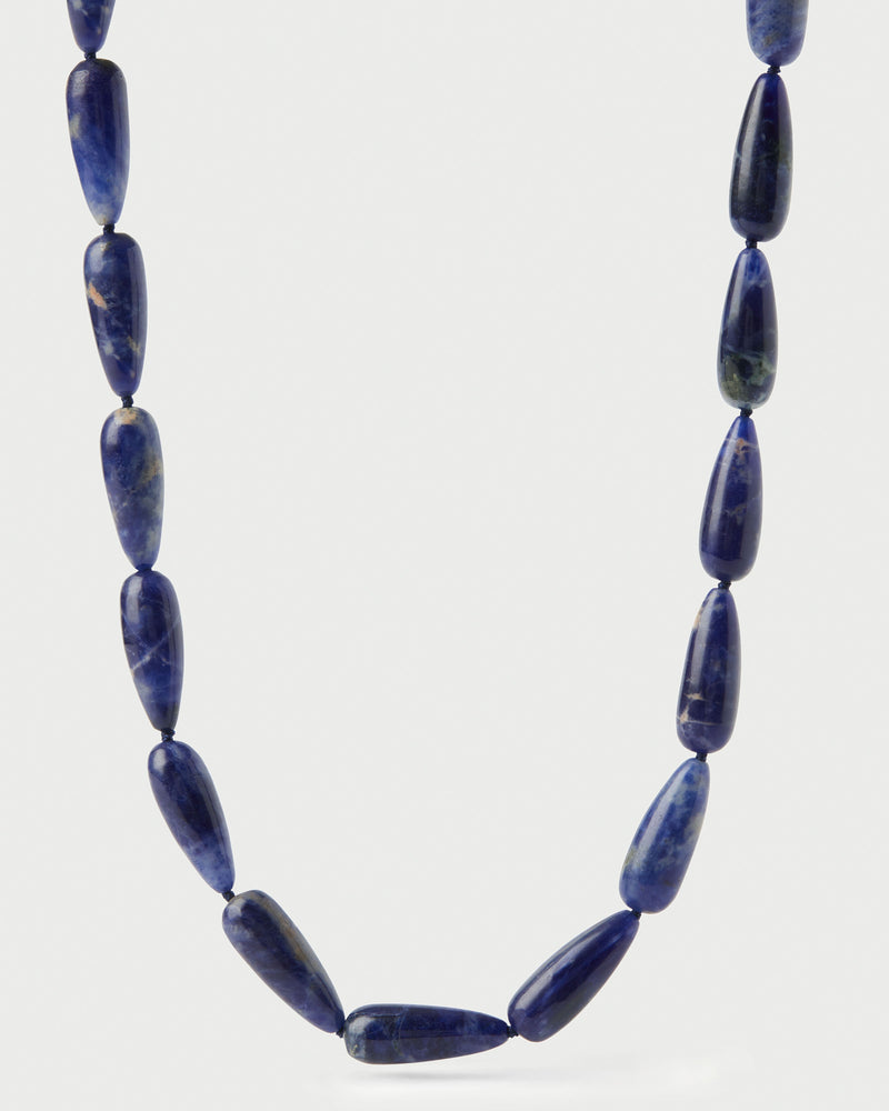 Modern choker featuring dark blue gemstone beads and signature drop closure