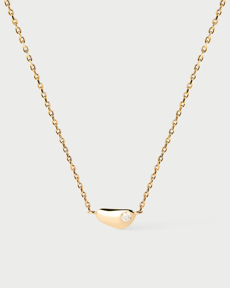 Gold-plated minimalist fluid shape necklace embellished with a flush set zirconia pendant